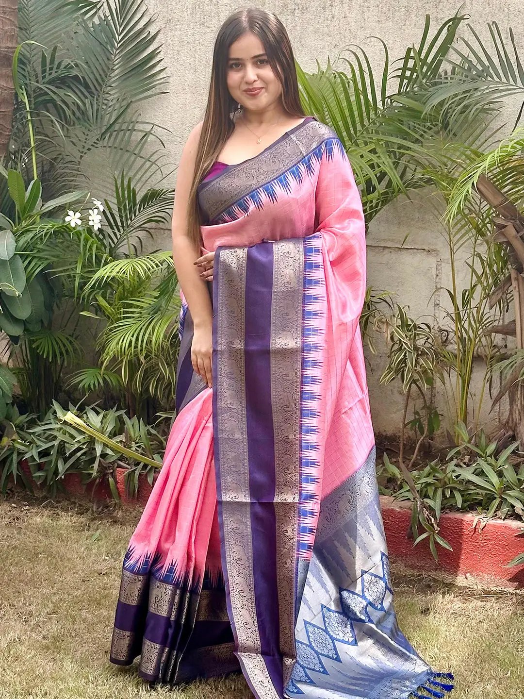 Model showcasing pink silk saree with gold zari chex work