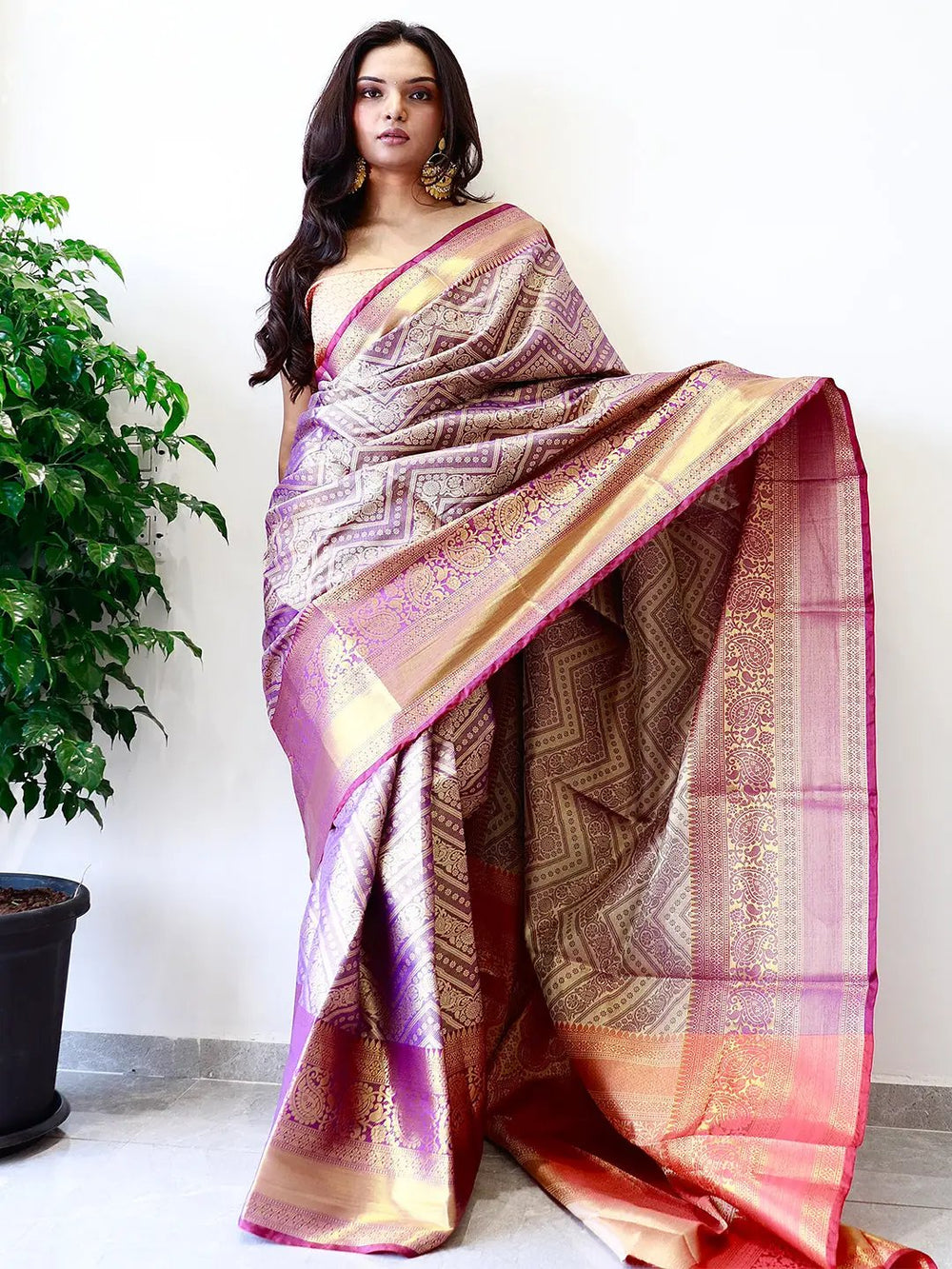 Elegant gold zari Kanjivaaram pattu silk saree draped gracefully.