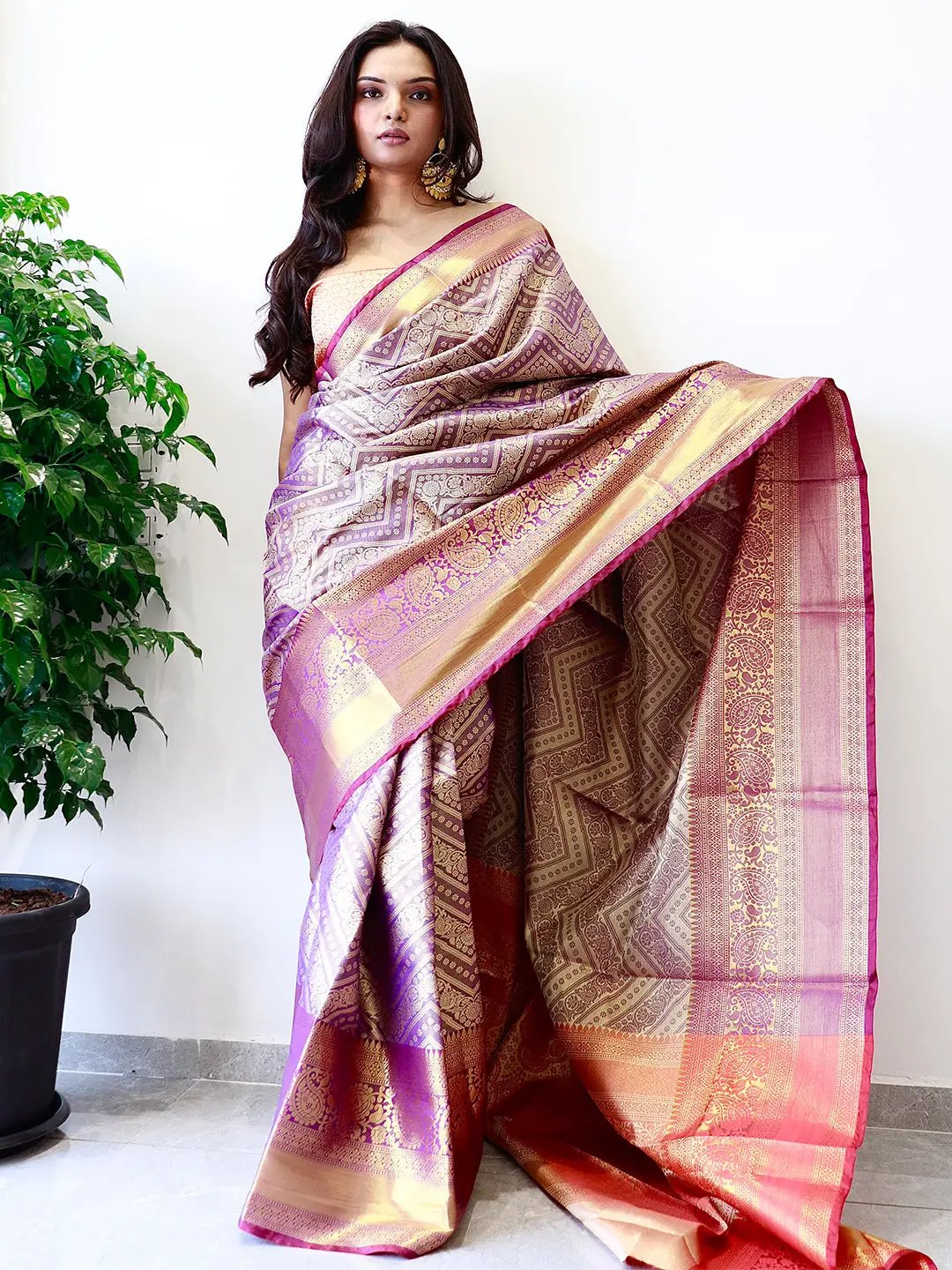 Elegant gold zari Kanjivaaram pattu silk saree draped gracefully.