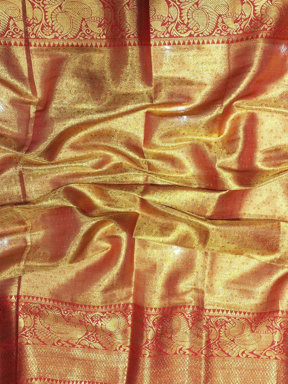 Close-up of red and gold Banarasi silk saree fabric