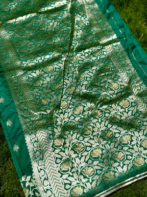 Detailed view of green silk saree with gold floral and geometric designs