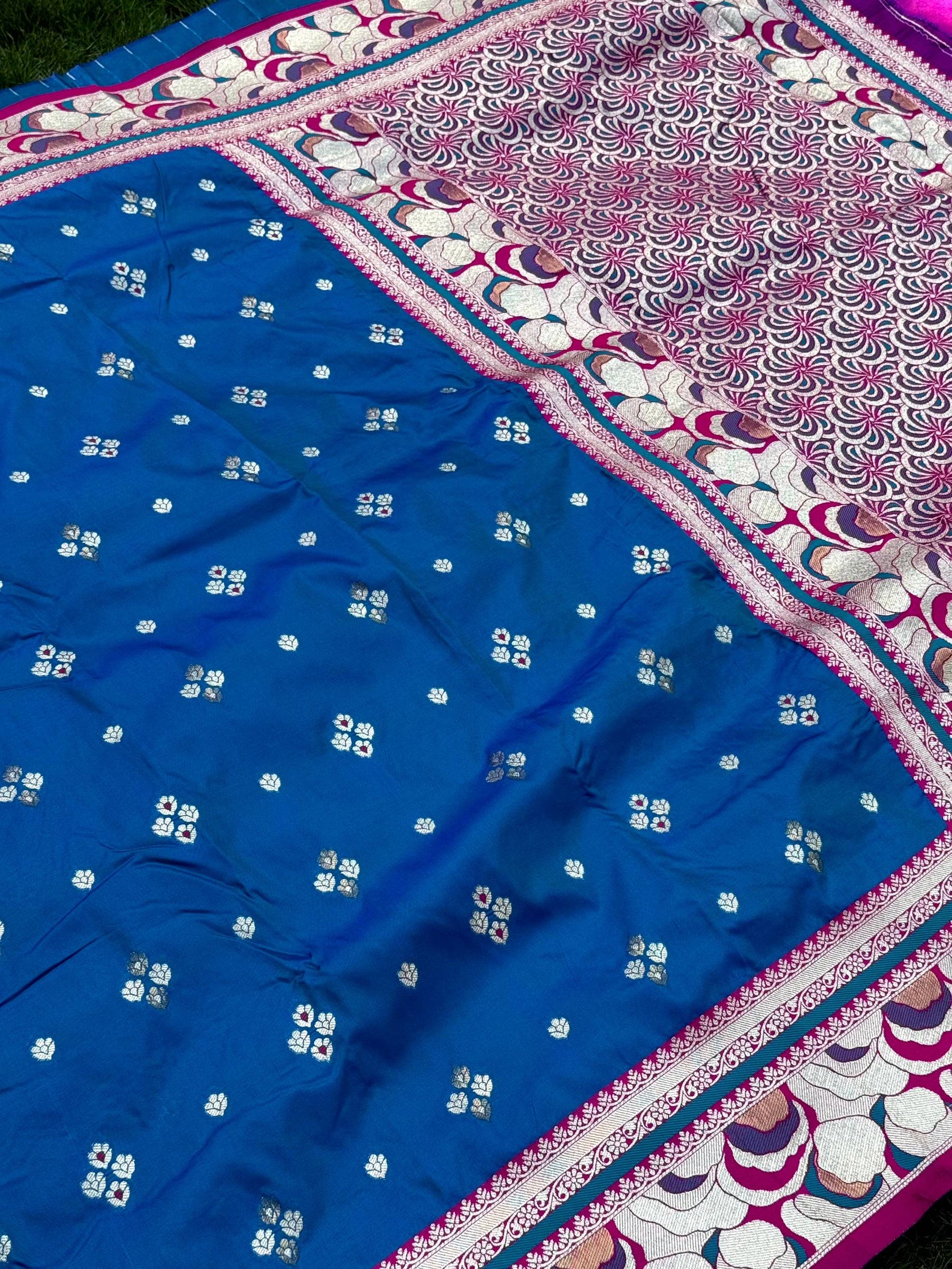 Blue silk saree with floral embroidery and decorative border