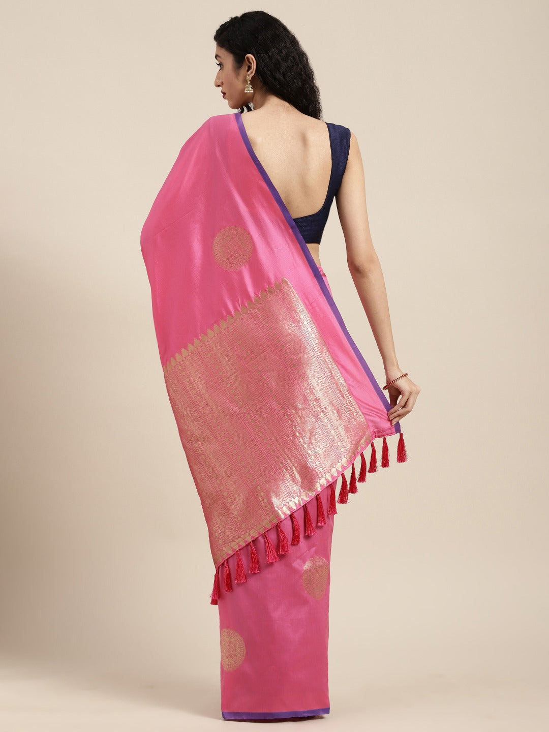 The saree boasts a rich Banarasi woven design, meticulously crafted by skilled artisans.