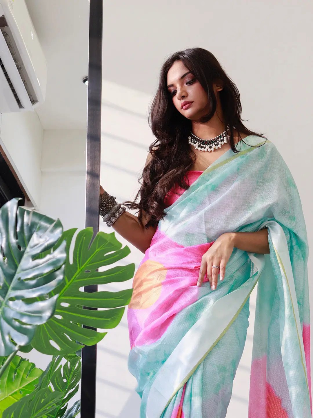Model wearing sky blue tie dye satin Kota Doriya saree