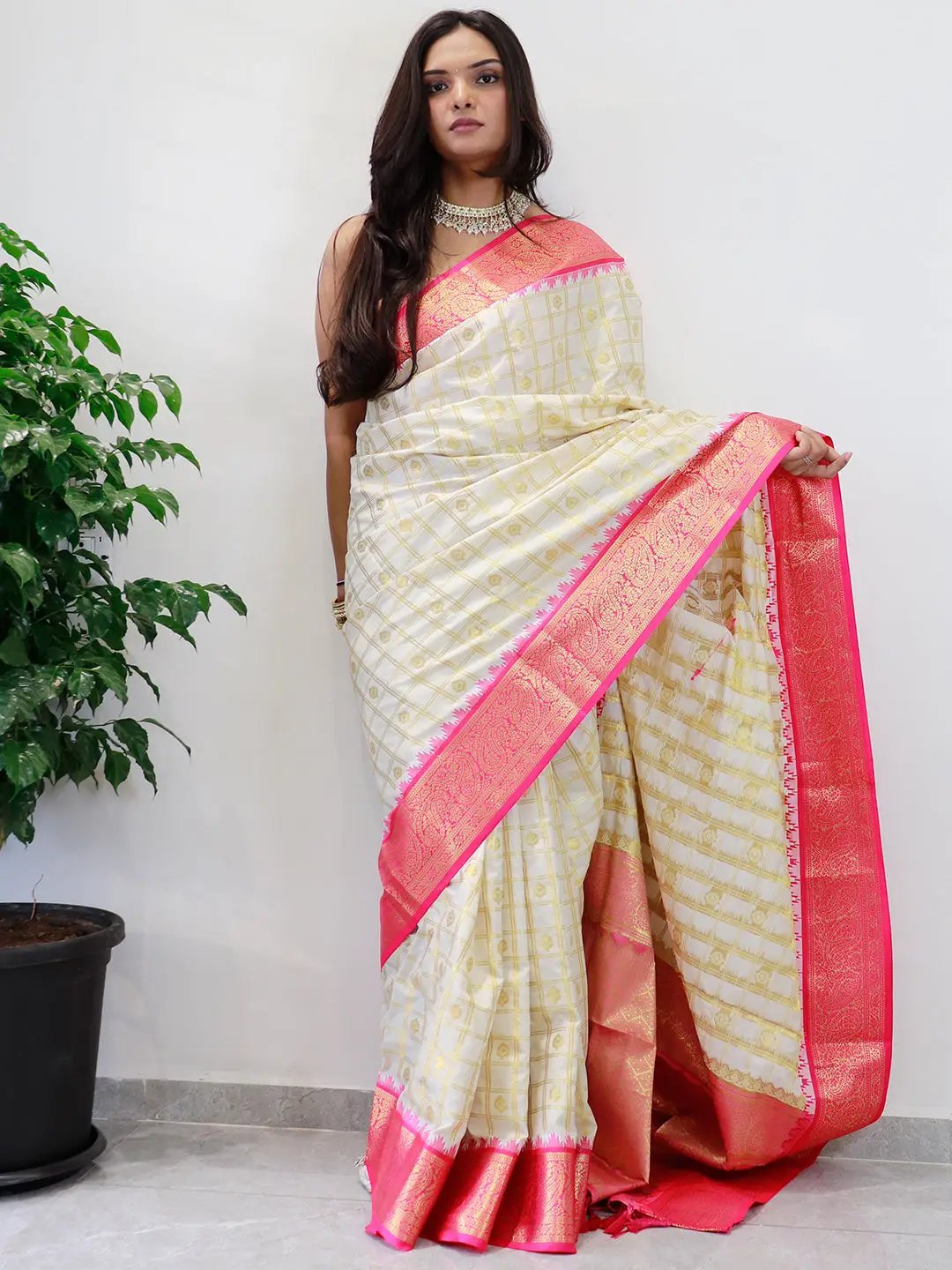 Elegant Gadwal saree with pink temple border draped on model.