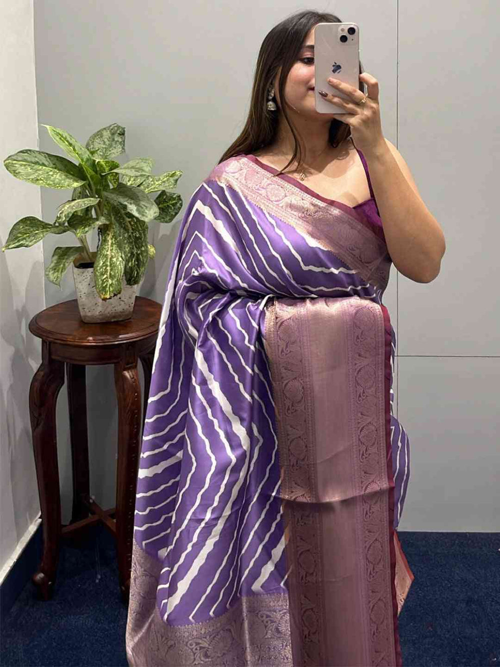 Purple leheriya saree with Kanchi zari border, worn by a woman.