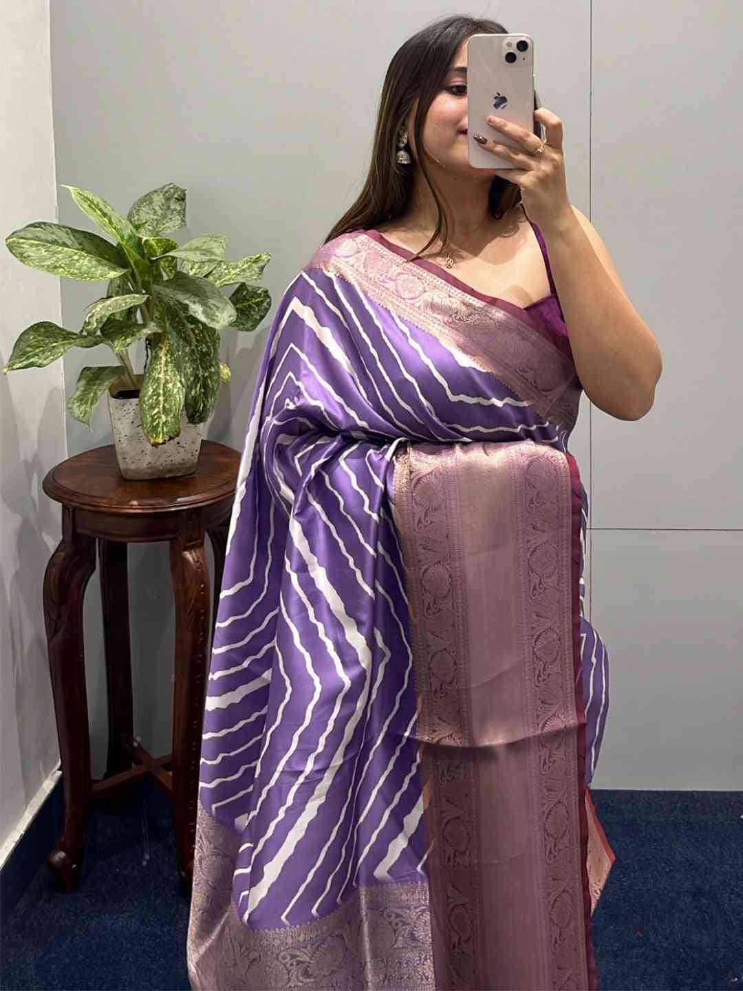 Purple leheriya saree with Kanchi zari border, worn by a woman.