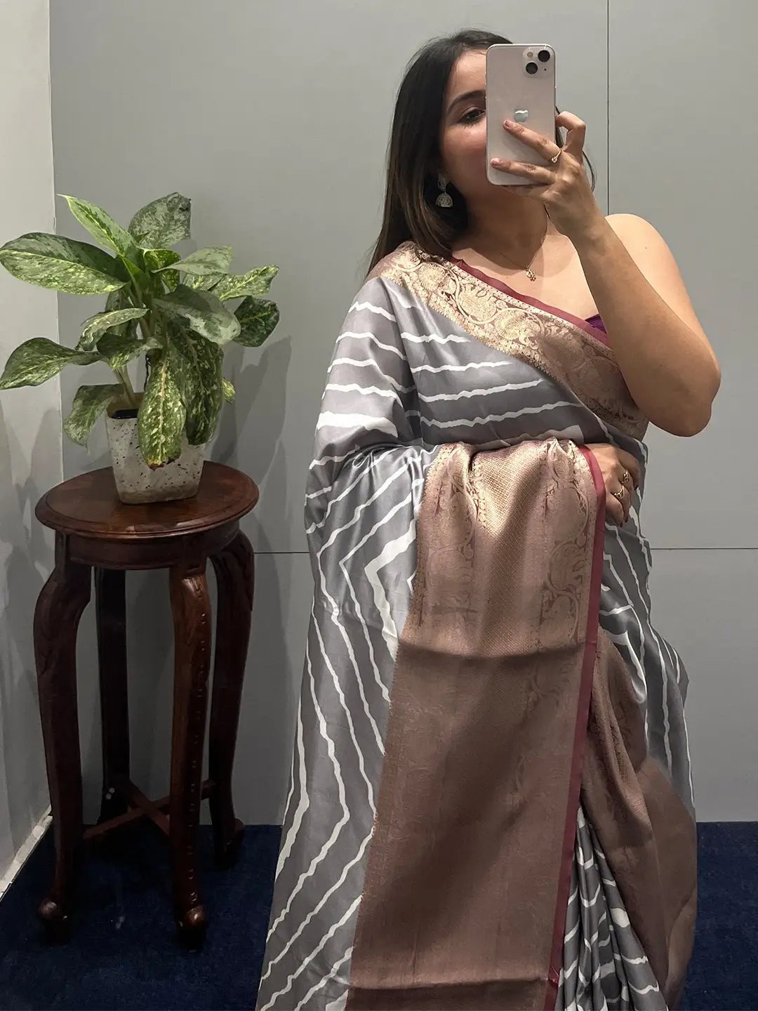 Model wearing Kanchi Zari Border Leheriya Saree with plant decor