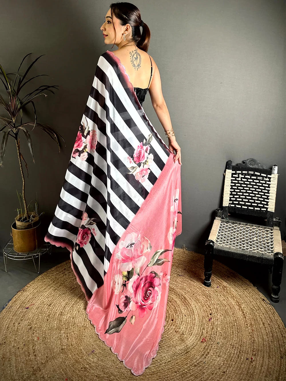 Black and white Soft Chinnon rose floral print saree, back view with the pink rose print pallu draped over the shoulder