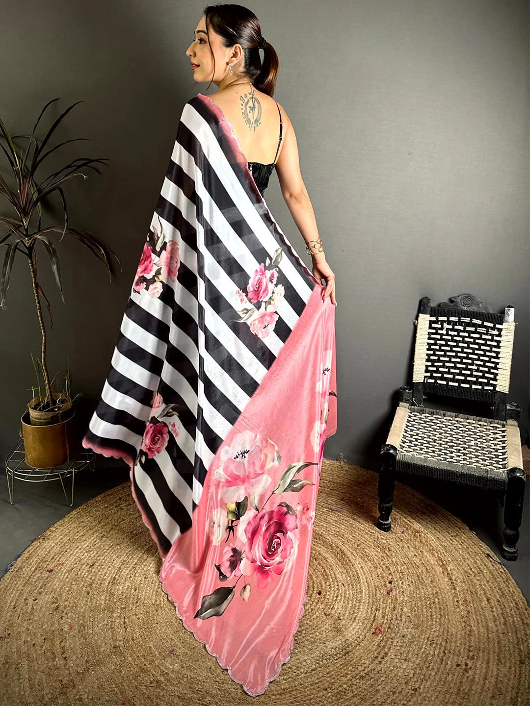 Black and white Soft Chinnon rose floral print saree, back view with the pink rose print pallu draped over the shoulder