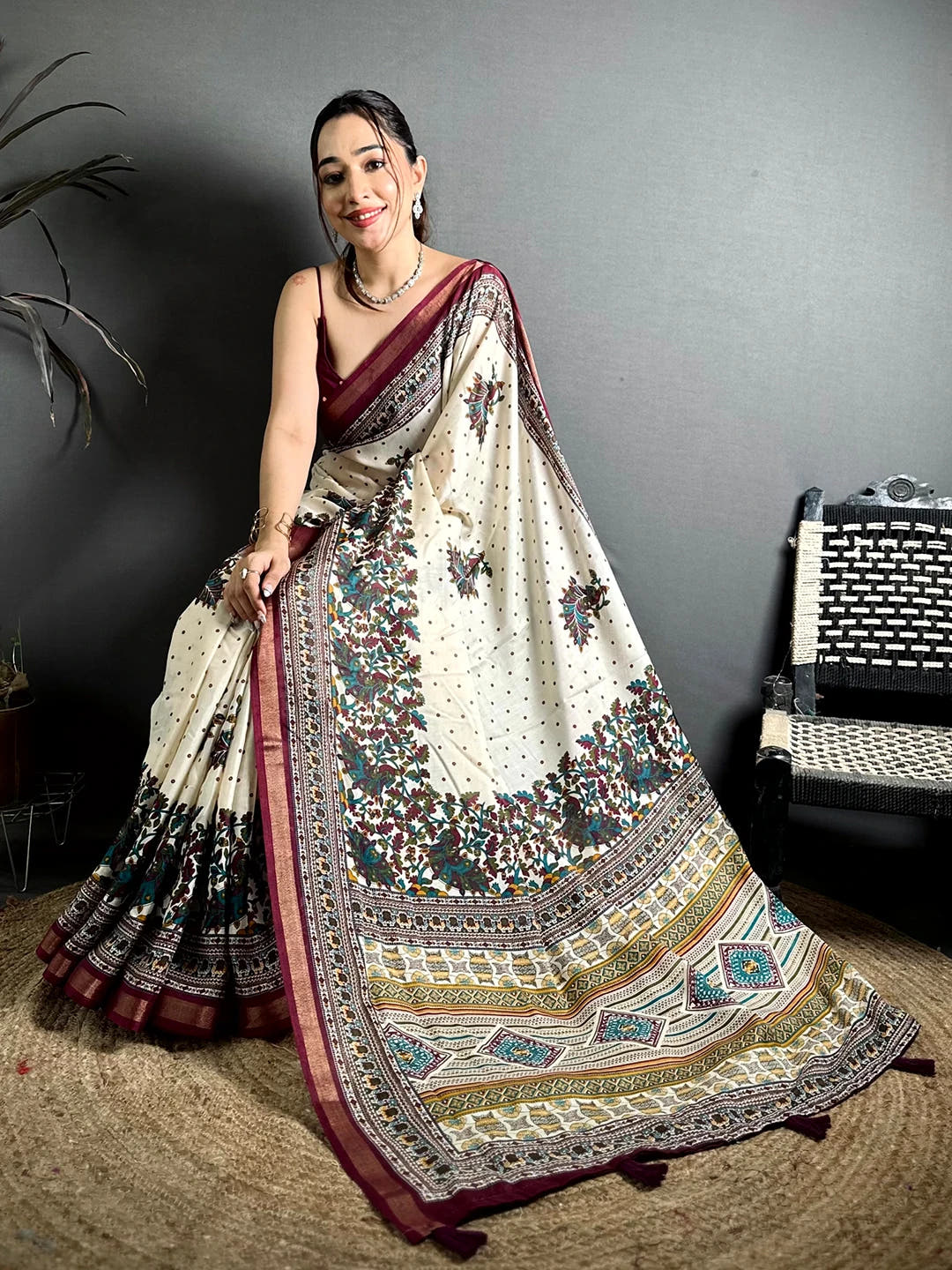 Cream mul cotton kalamkari print saree, full length drape on a model with geometric printed pallu and maroon border
