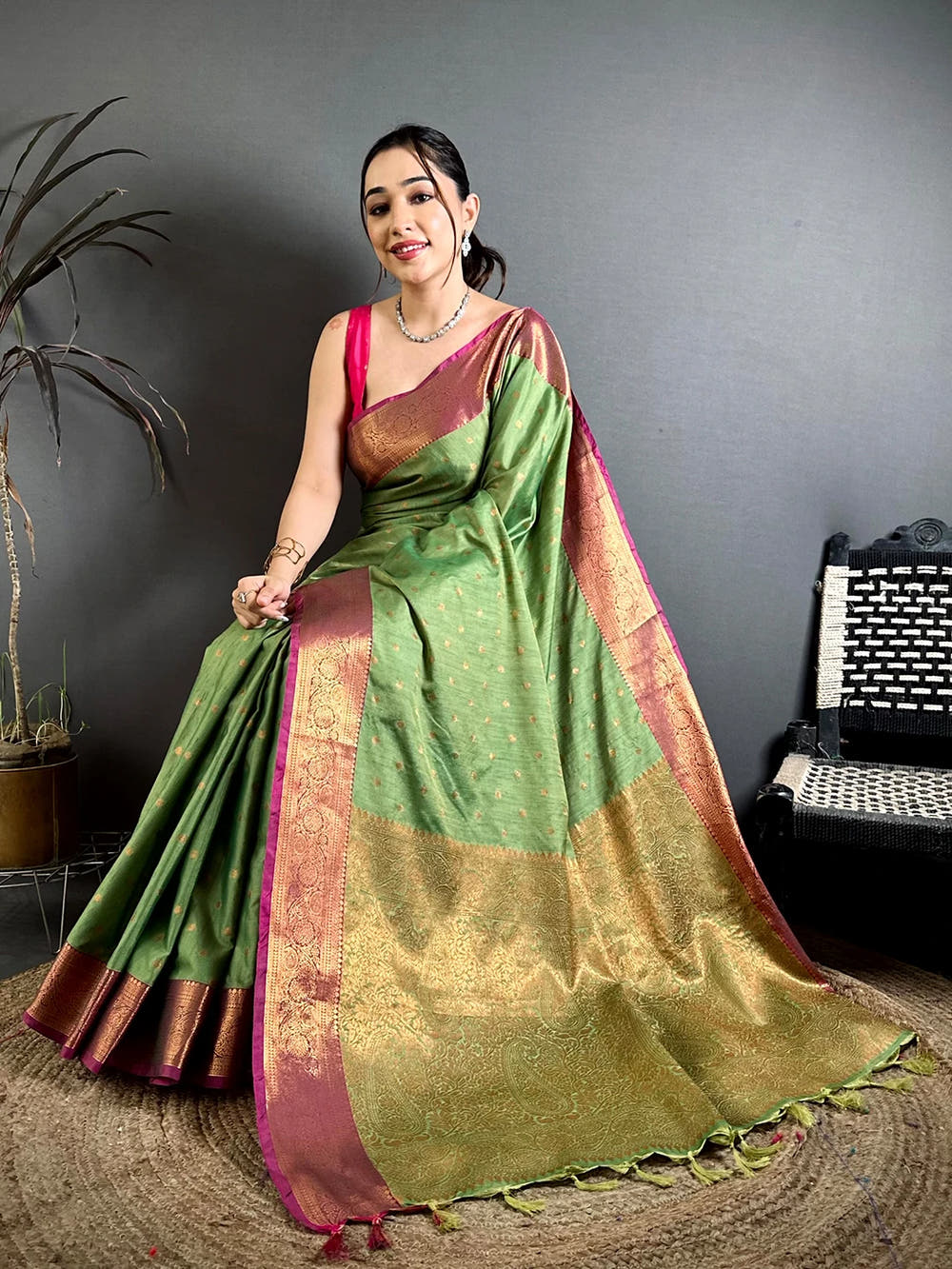 Pista Green Raw Silk woven buti saree, seated model showing the gold woven pallu and the maroon zari border