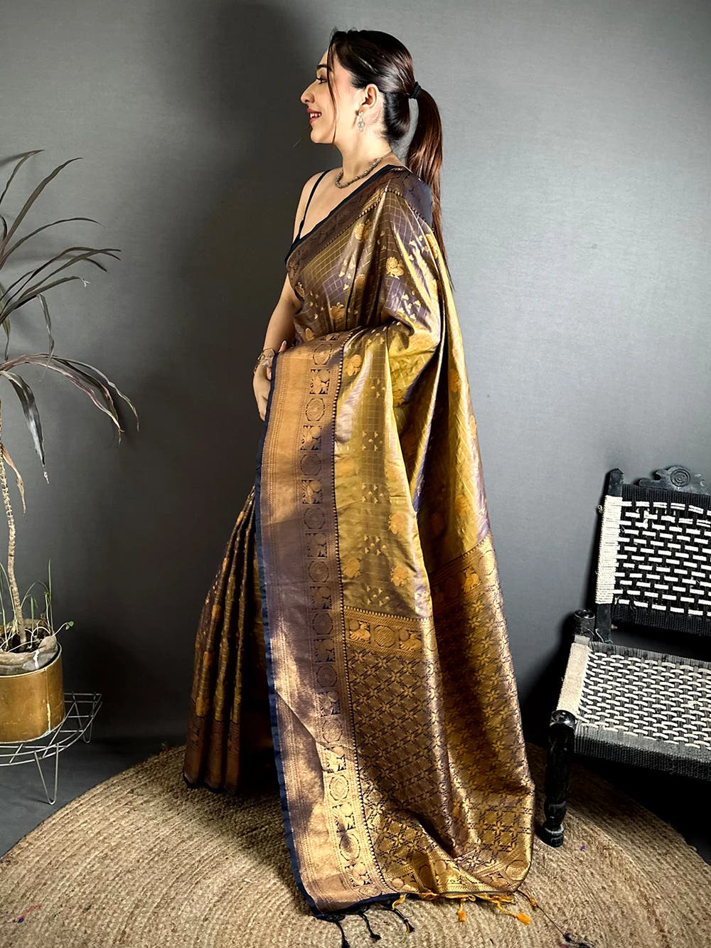 Deep bronze soft silk Kanchi-style saree, side view of drape showing the woven pallu and navy edged border