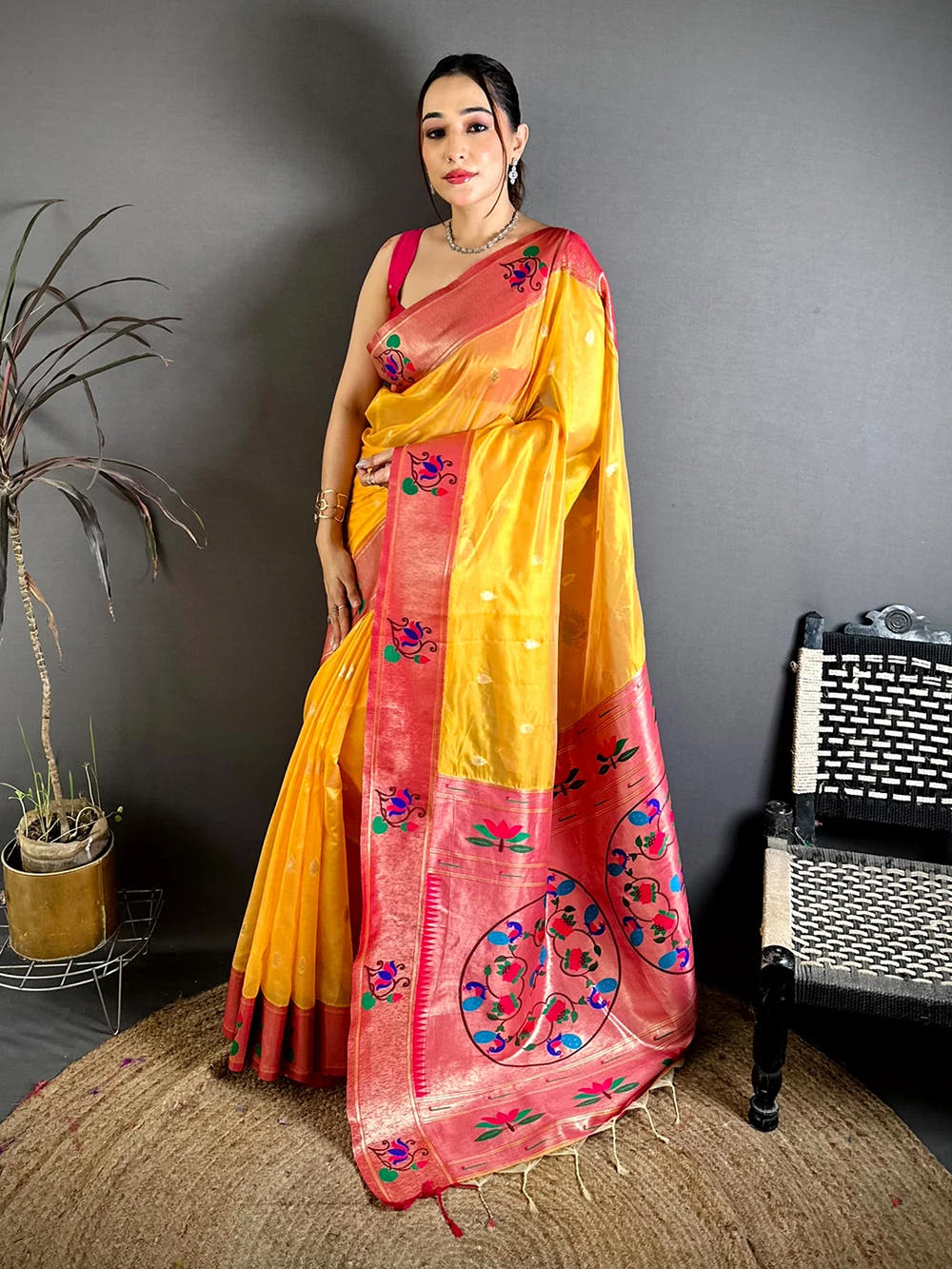 Yellow Organza Tissue Paithani-style saree, full length front drape on a model standing on a jute rug with red border at the