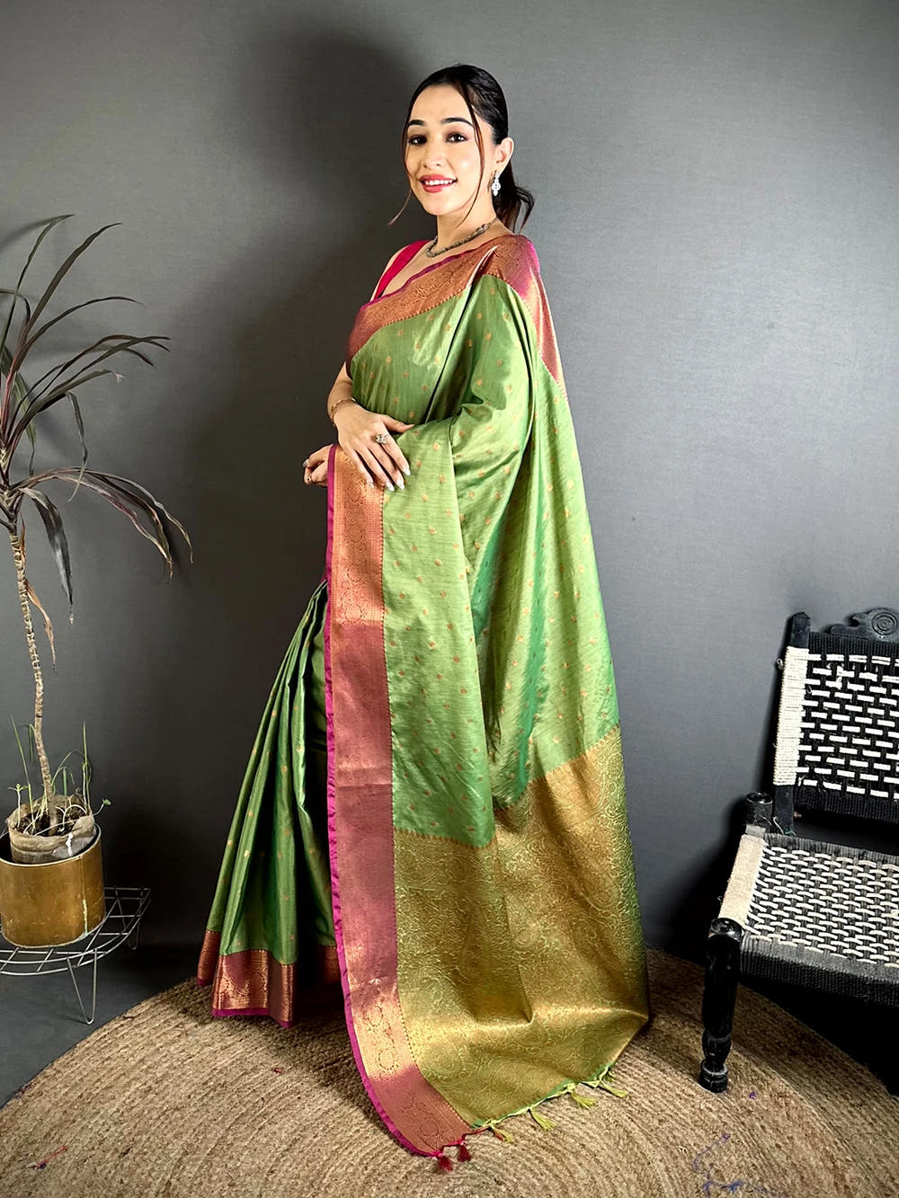 Pista Green Raw Silk woven buti saree, side view showing the pink edging and the woven pallu falling to the floor