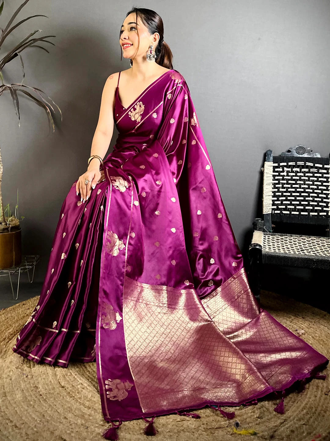Wine Mashru Satin Silk Elephant Zari Butta Saree, seated model showing the zari border and the lower pleats