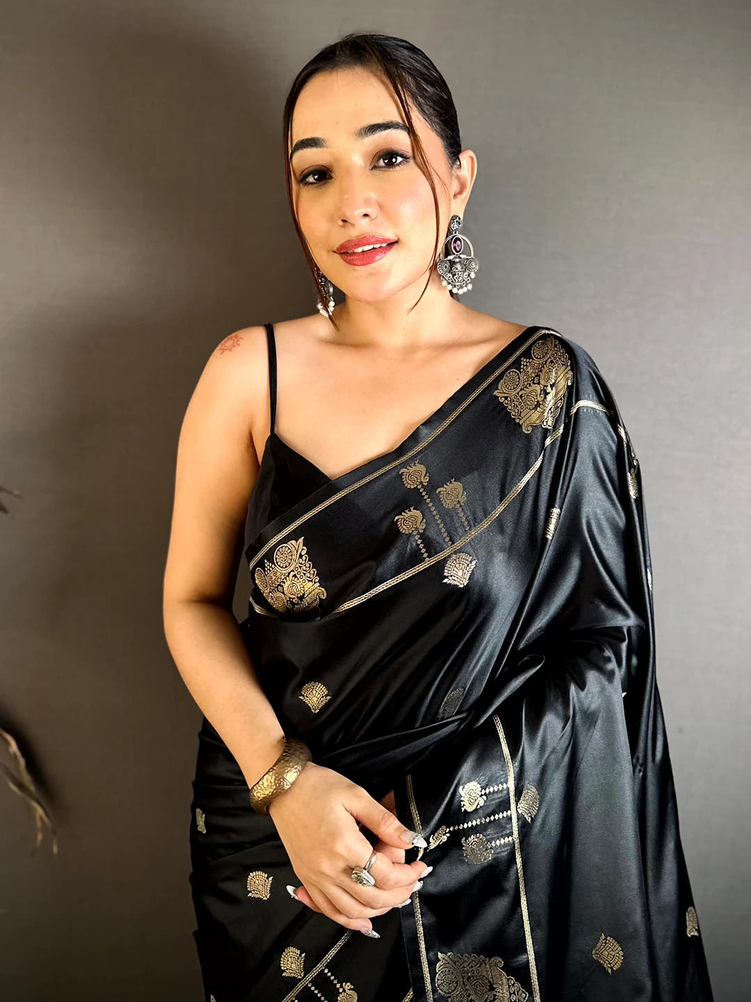 Black Mashru Satin Silk zari peacock butta saree, front close-up on model showing the butta and zari border at the shoulder