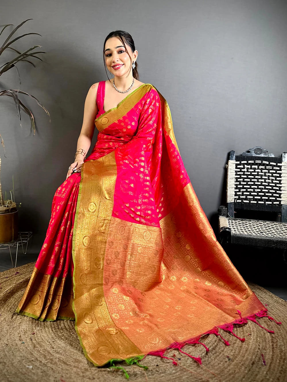 Pink soft silk floral zari butti saree, front view with pallu spread out showing pink and green tassels