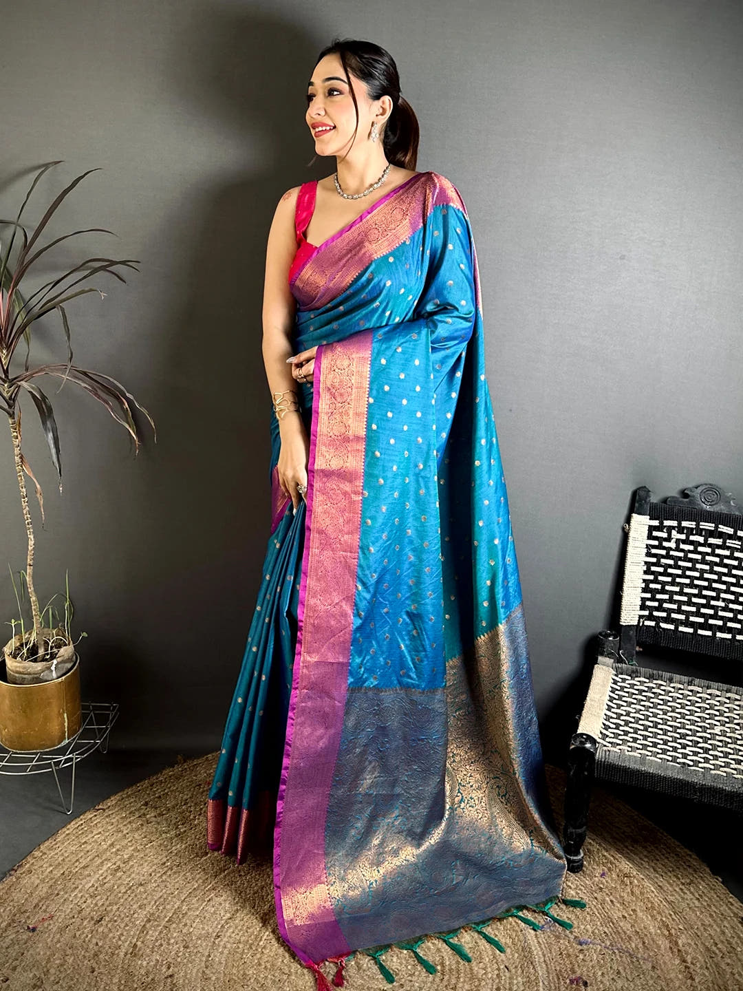 Royal Teal Raw Silk Woven Buti Saree, full-length standing view showing gold-tone buttas and the woven pallu with tassels