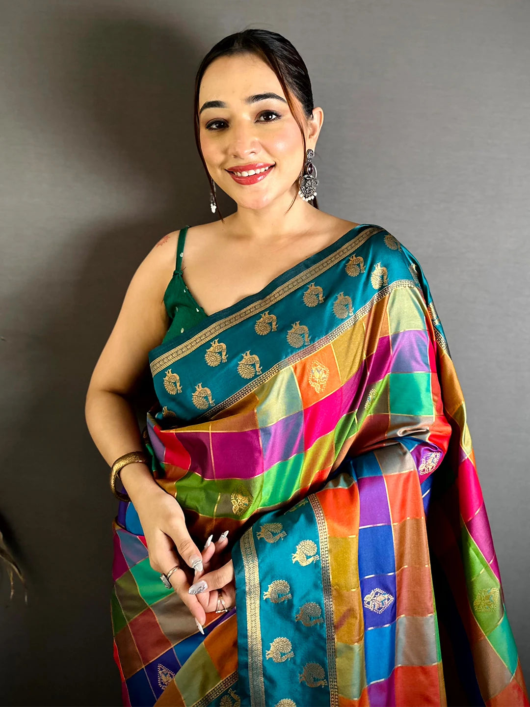 Teal multi colour soft silk Pallampazam-style chex saree, front drape on a model with teal border and gold motifs