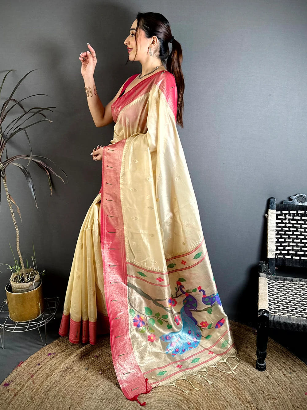 Cream organza tissue Paithani-style saree, side view of the drape with pink border and small buti motifs