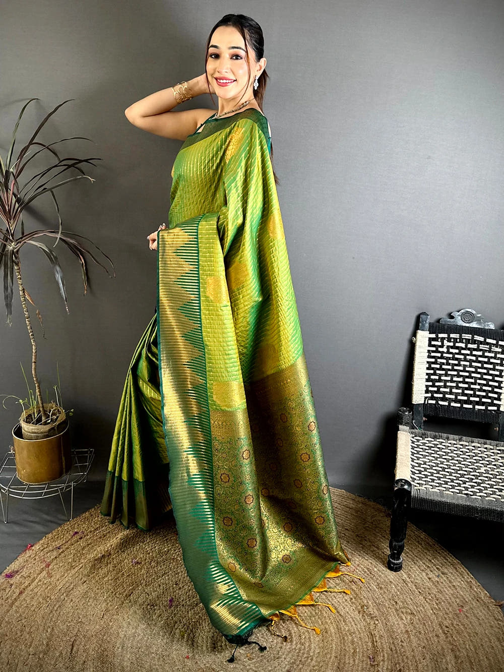 Green Soft Silk Zari Weave Saree, side view of model showing the zari striped pallu and green border