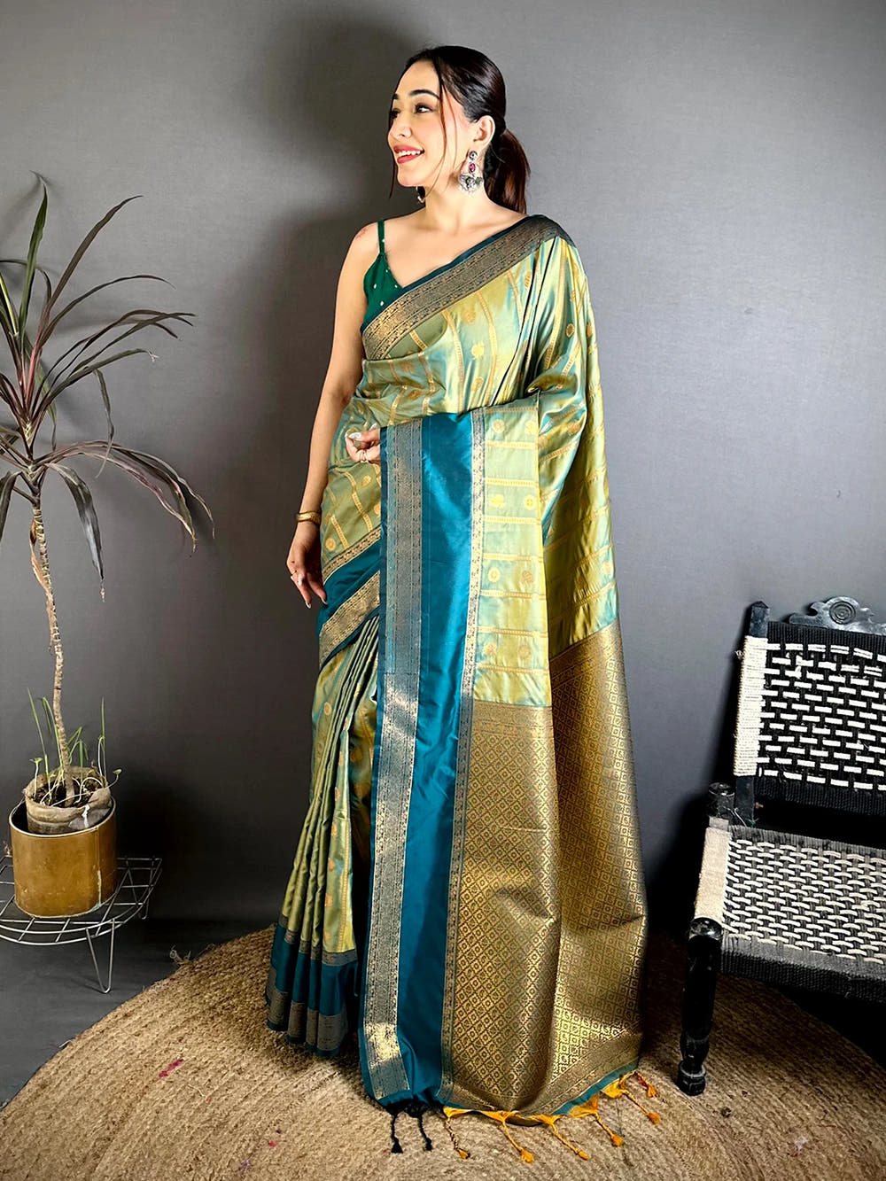 Pista green Banarasi silk zari butta saree, full standing view showing the rich woven pallu with tassels