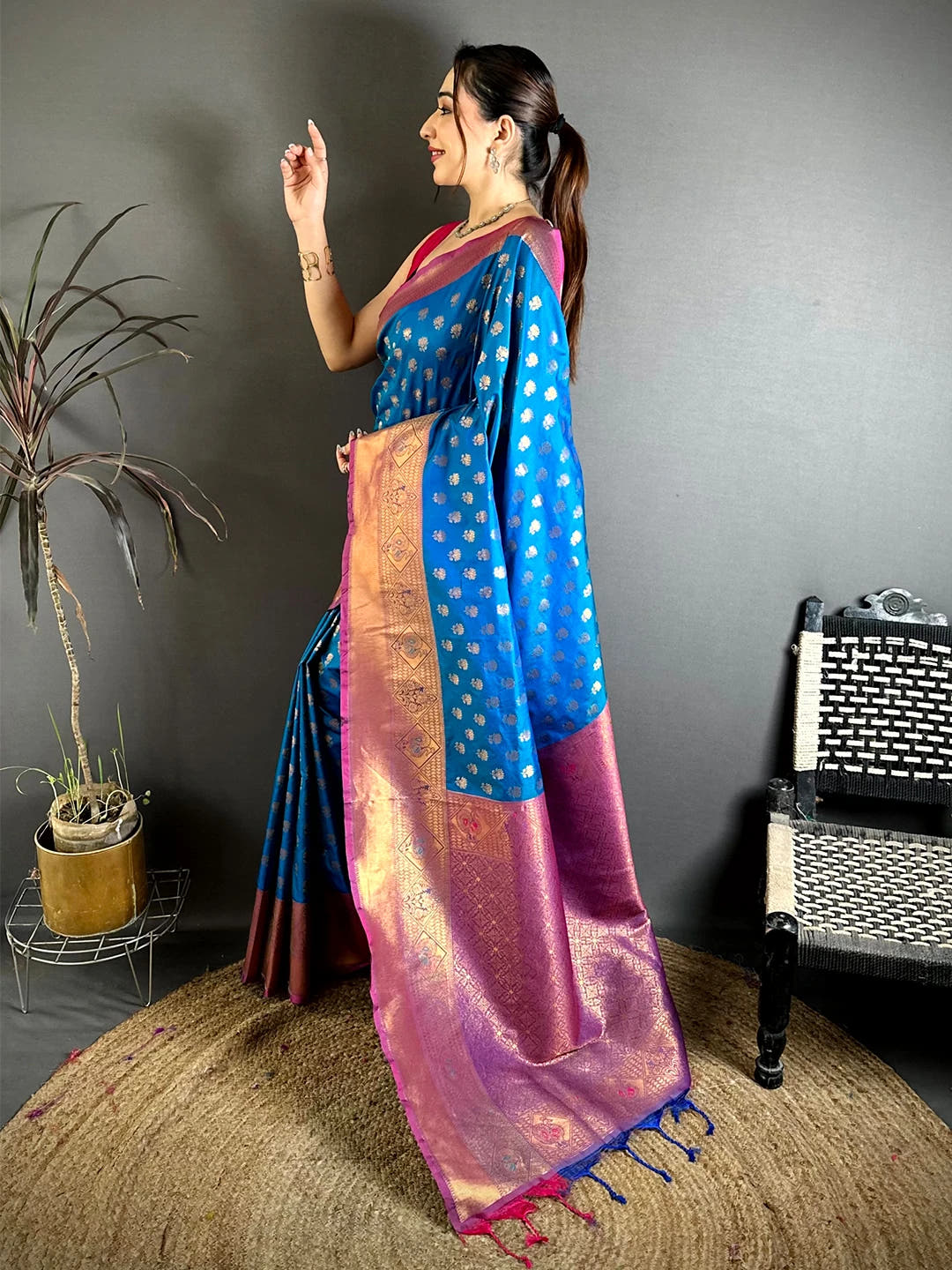 Blue soft silk lotus zari butti saree, side view showing the pallu drape and woven copper border