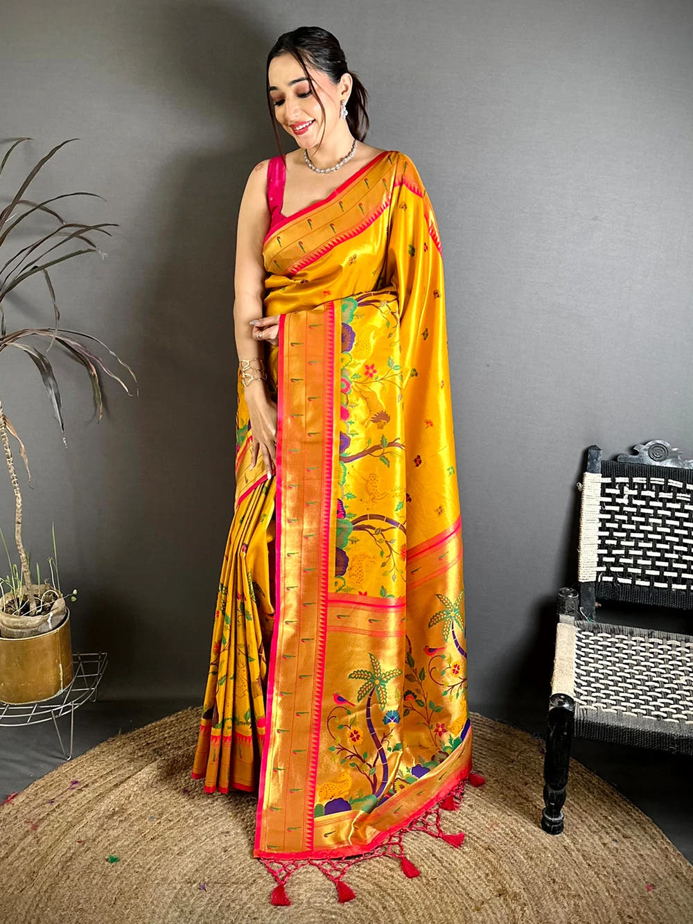 Mustard Soft Silk Paithani-style woven saree, full drape on model with zari pallu and pink tasselled edge