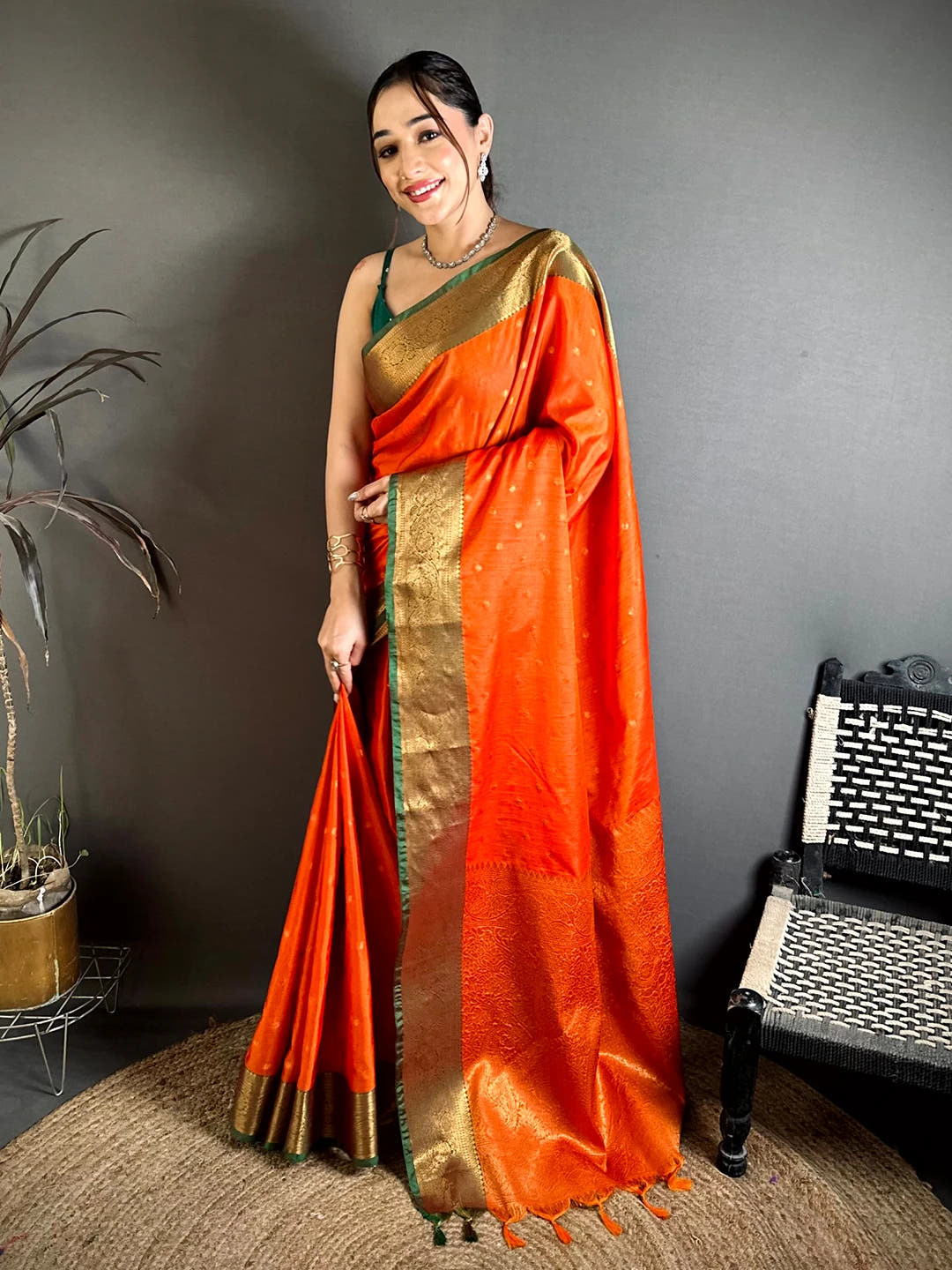Royal orange raw silk woven buti saree, full front drape on standing model with zari-style border and tasselled pallu
