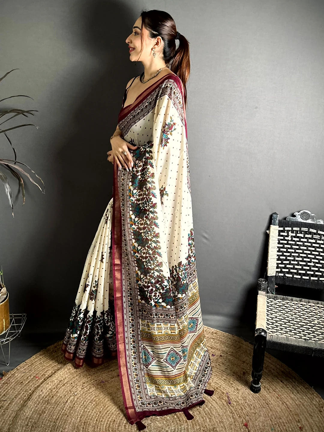Cream mul cotton kalamkari print saree, side view showing the maroon border and printed pallu with tassels