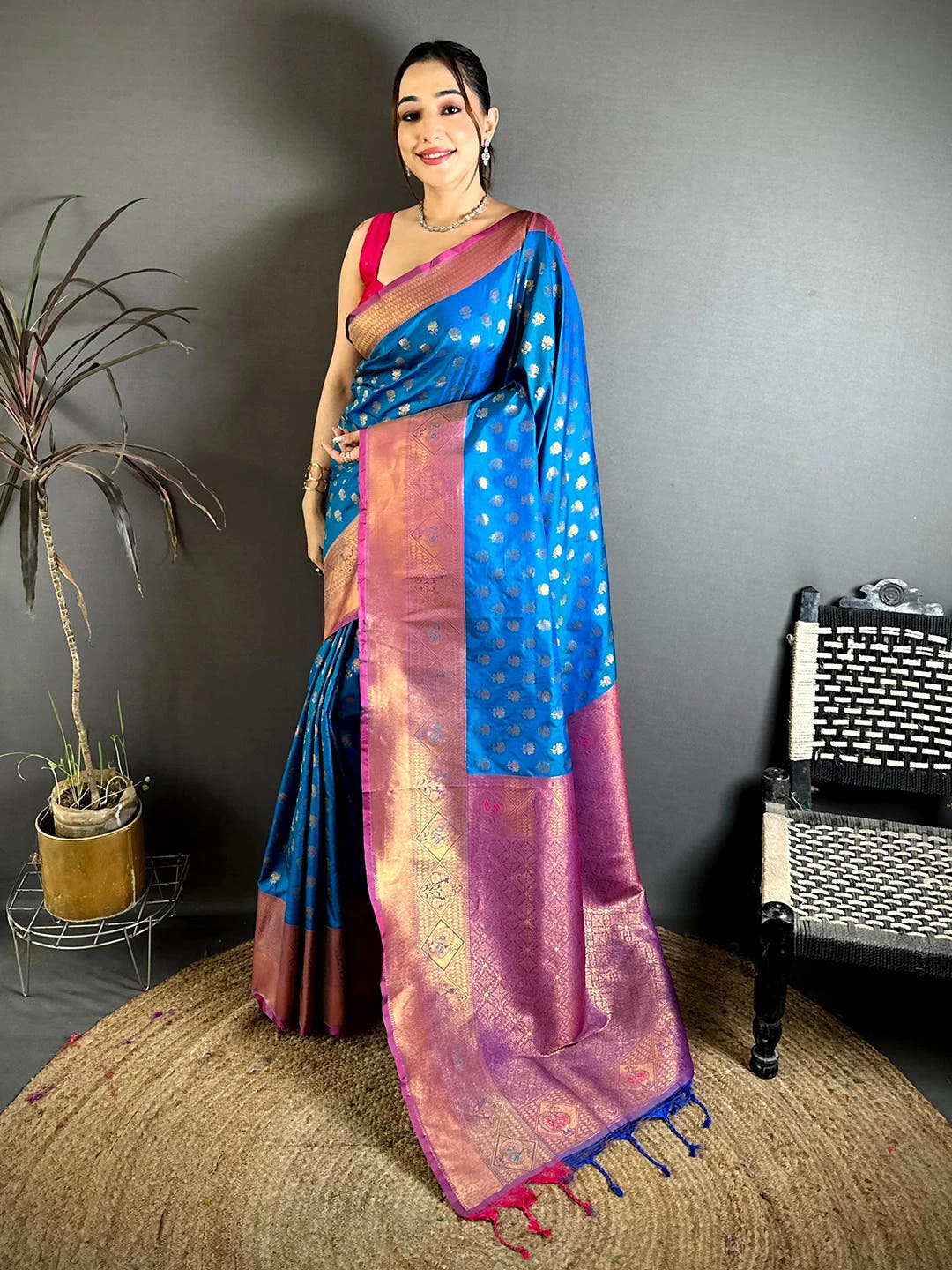Blue soft silk lotus zari butti saree, full-length front view with contrast pallu and pink and blue tassels
