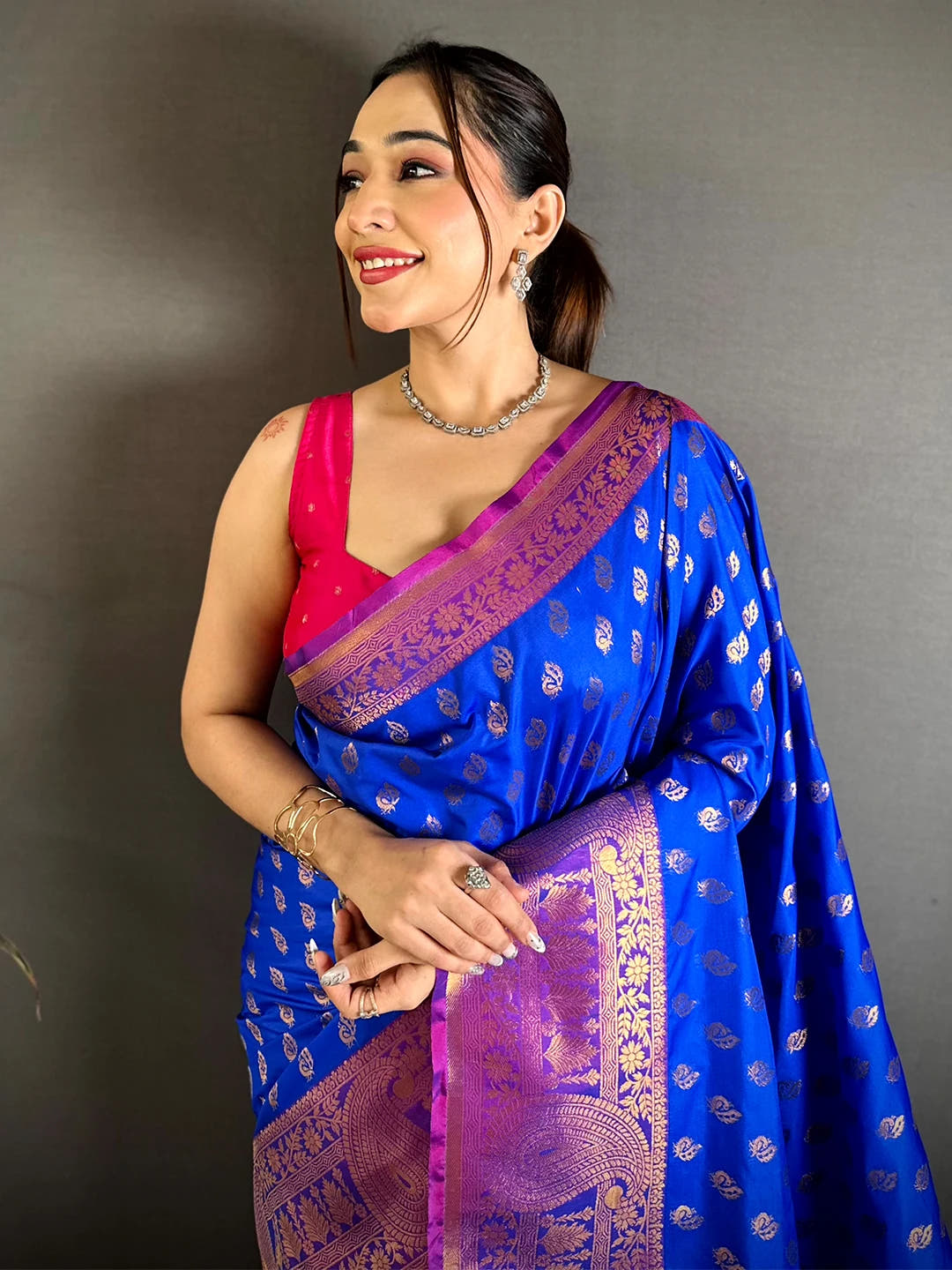 Royal blue soft silk zari woven buta saree, front drape on model with magenta kanchi pattu border and pink blouse