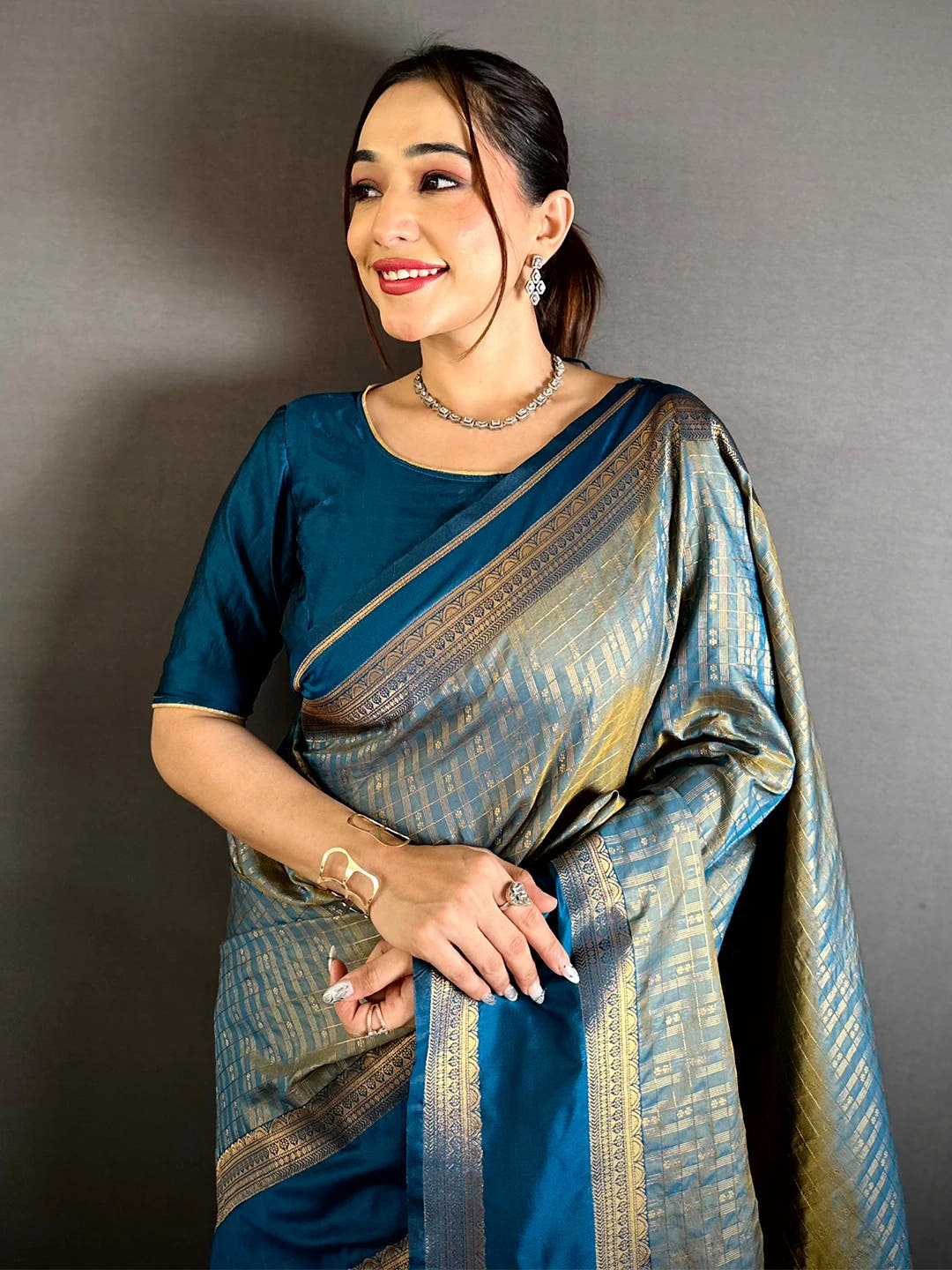 Teal Soft Silk Gold Checked Butta Saree, front drape on model showing the Gadwal border and blouse