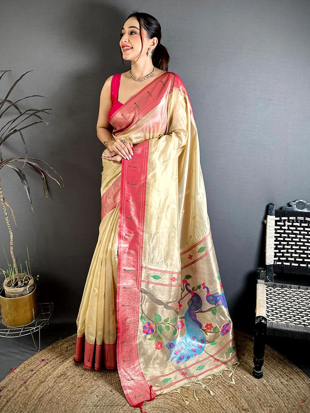 Cream organza tissue Paithani-style saree, full length standing view showing the pink border and peacock pallu