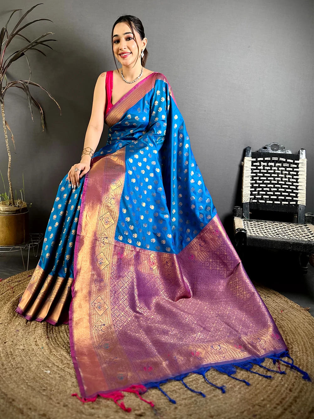 Blue soft silk lotus zari butti saree, pallu spread on a jute mat showing the woven pattern and tassels