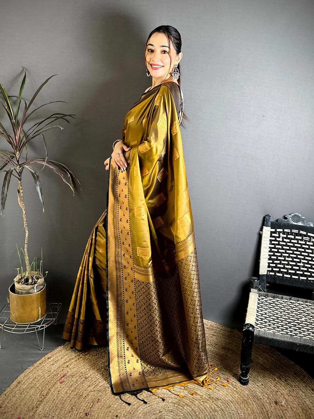 Mustard Katan Silk Peacock Cage Butti Saree, side view of the drape and pallu with tassels at the end