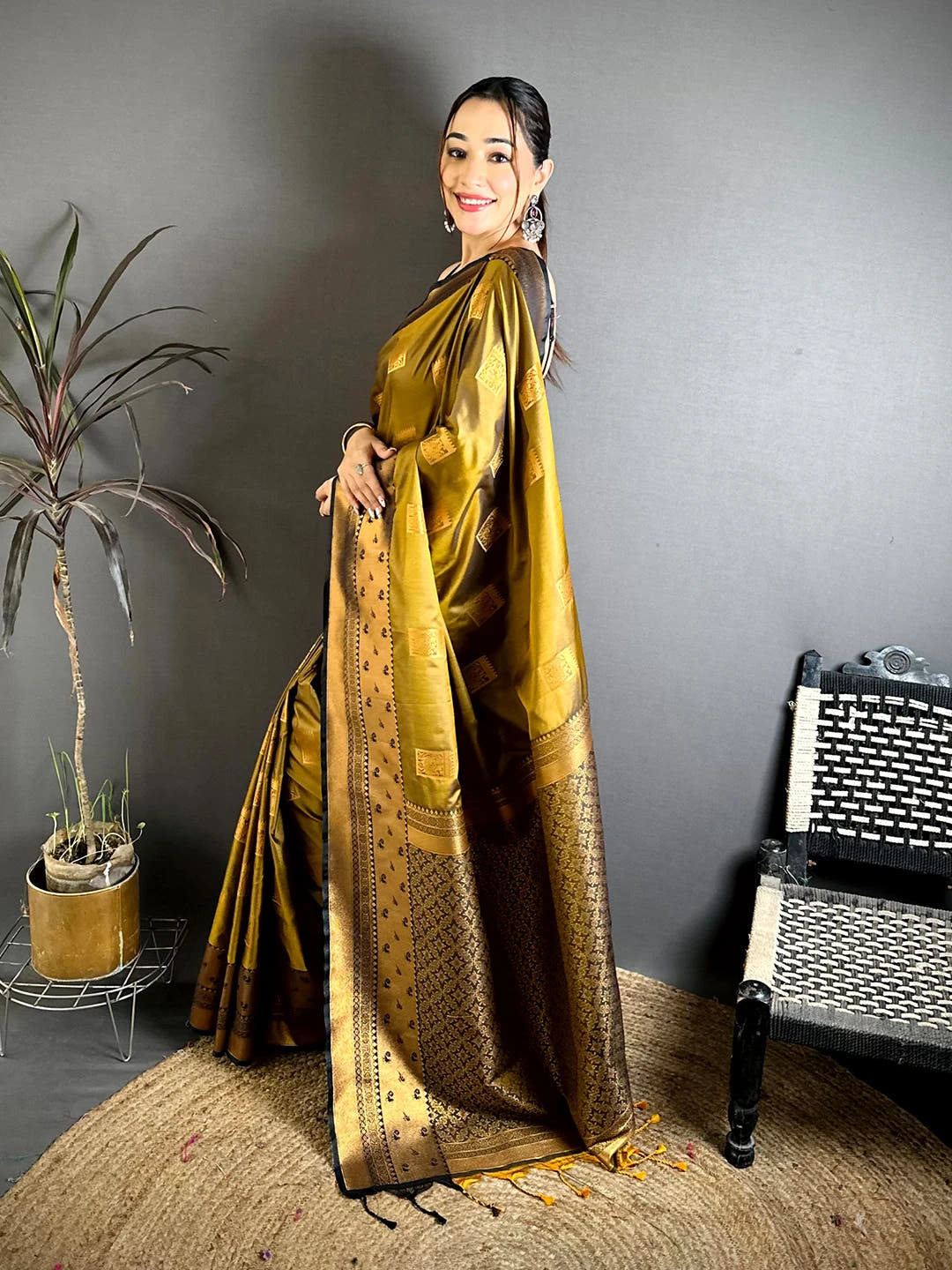 Mustard Katan Silk Peacock Cage Butti Saree, side view of the drape and pallu with tassels at the end