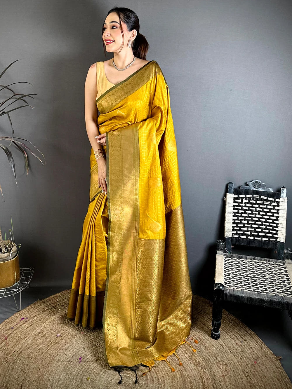 mustard silk checked zari saree, full length front view showing the zari pallu and tassels on a jute rug