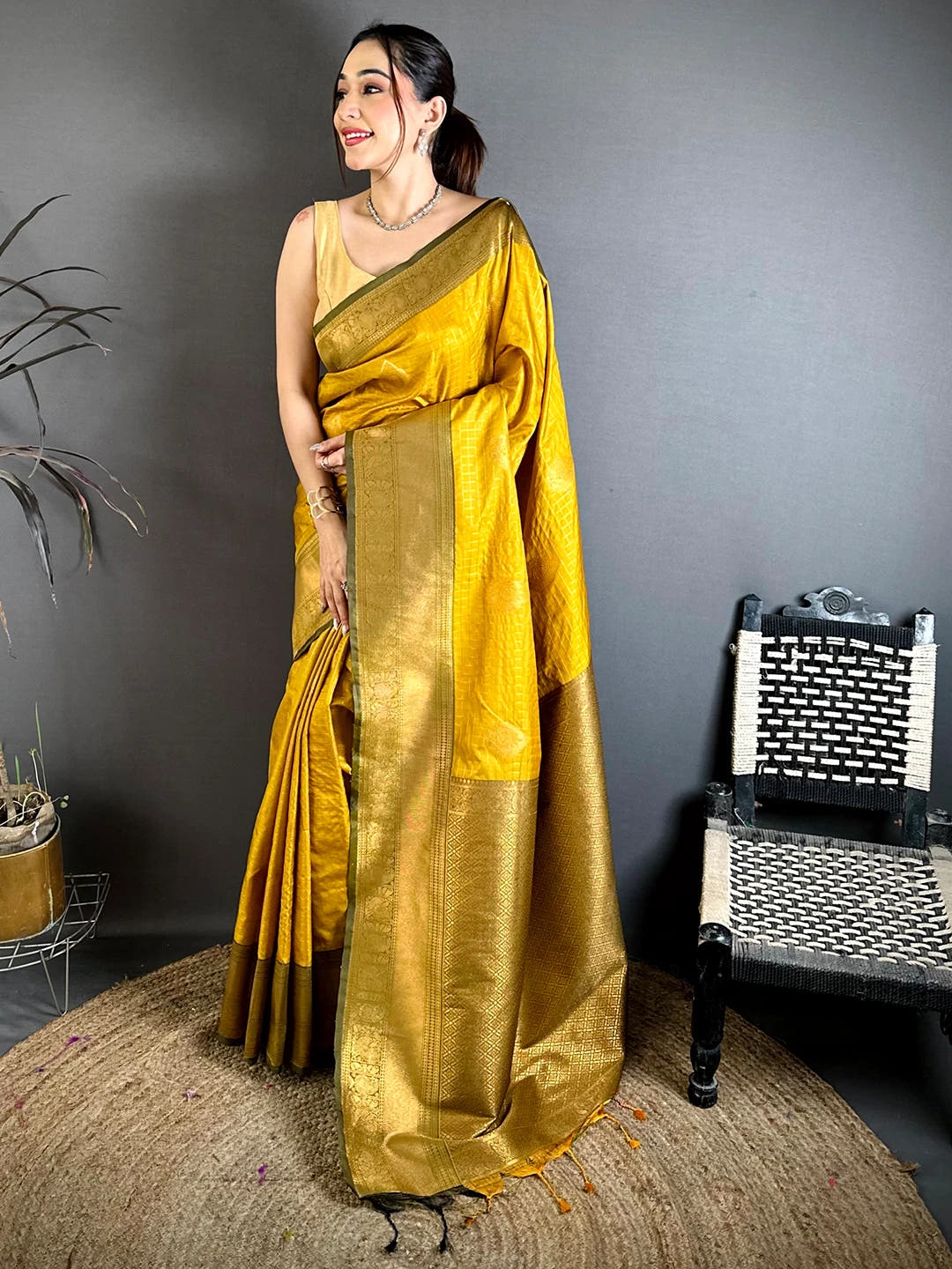 mustard silk checked zari saree, full length front view showing the zari pallu and tassels on a jute rug