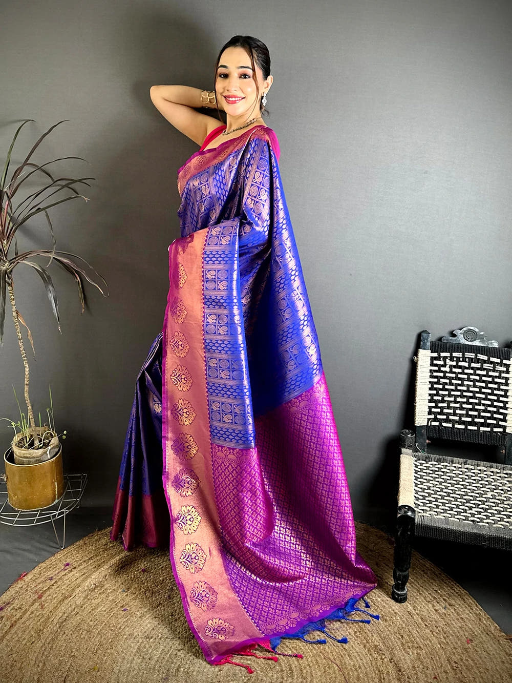 Royal blue soft silk zari woven saree, side view showing the zari buti motifs and magenta pallu with tassels