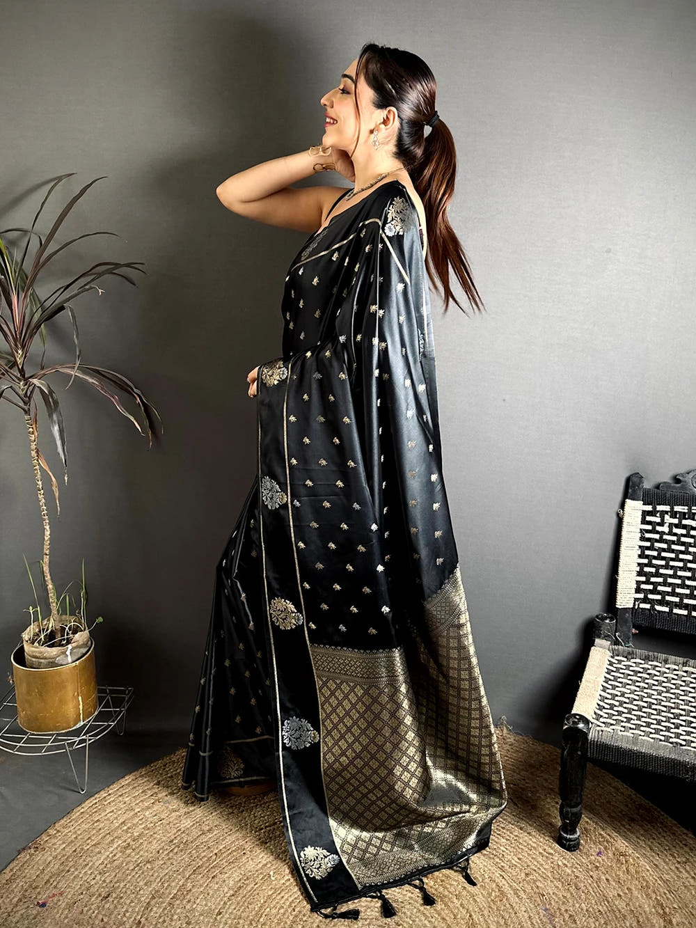 Black Mashru Silk Zari Butta Saree, side view on a model showing the zari border with thin gold lines along the drape