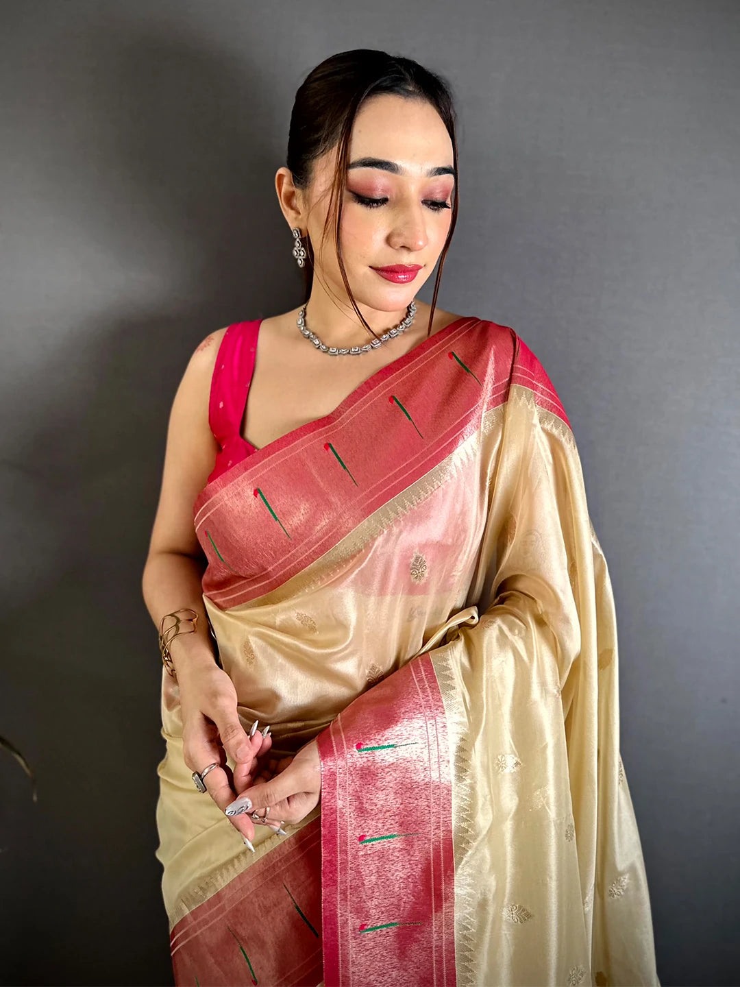 Cream organza tissue Paithani-style saree, front drape on a model with pink border and pink blouse