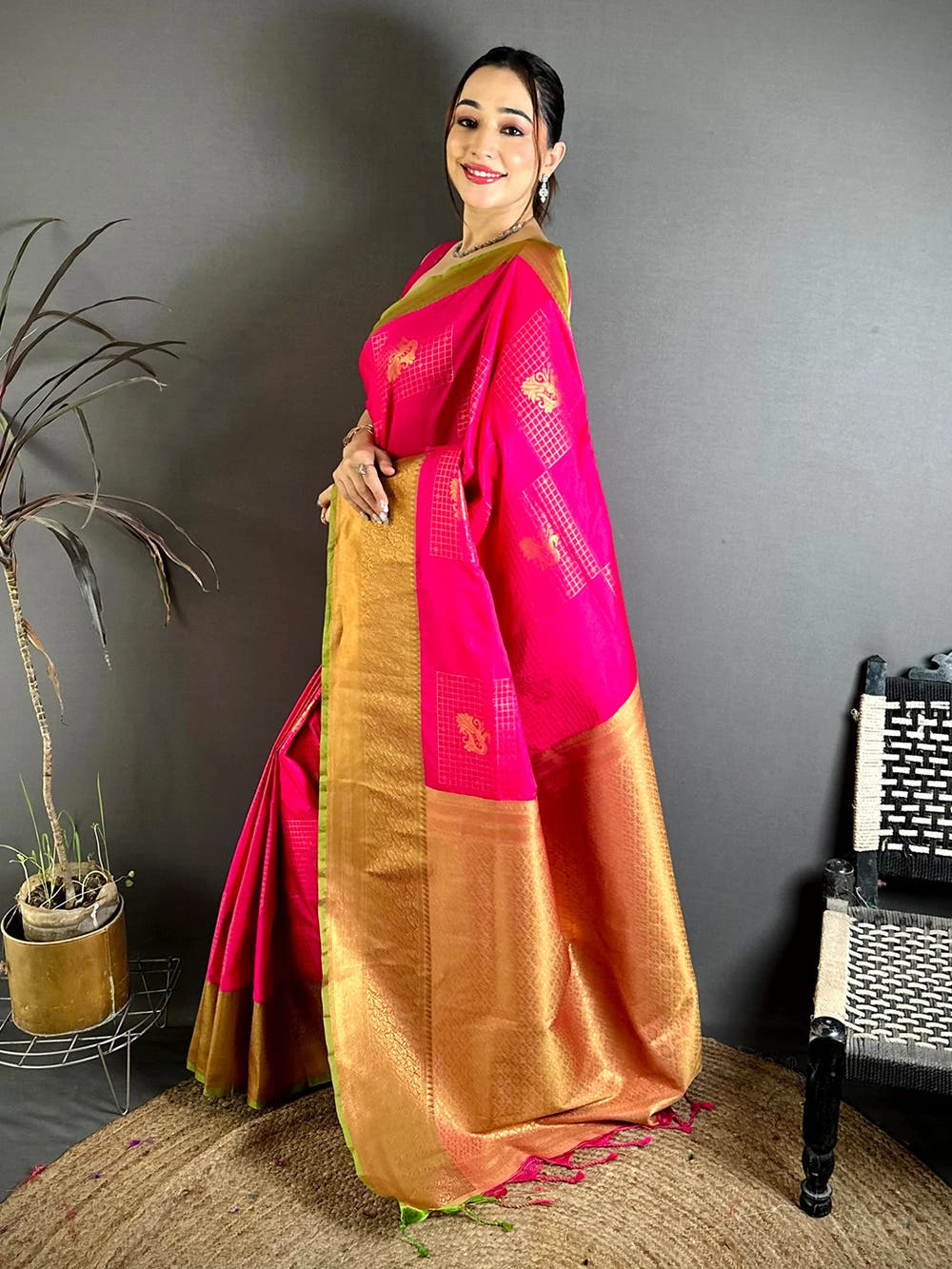 Pink Soft Silk Zari Butti saree, side view of the drape showing the broad zari border and pink tassels at the pallu end
