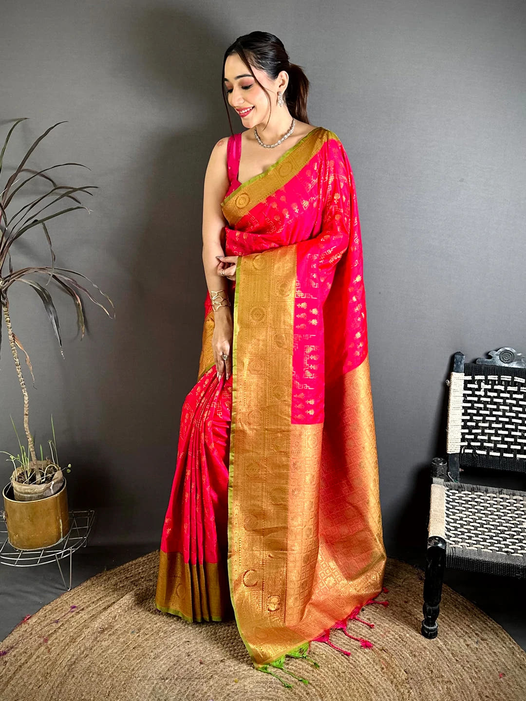 Pink soft silk floral zari butti saree, full length view on model showing the zari border and jute mat setting