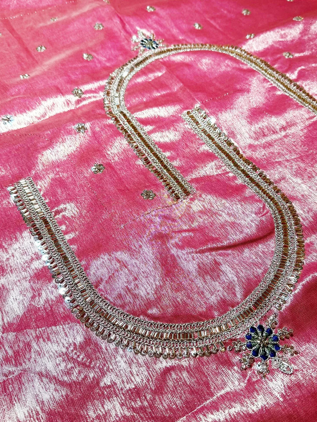 Cream organza tissue Paithani-style saree, close-up of the pink blouse neckline with zari and bead work
