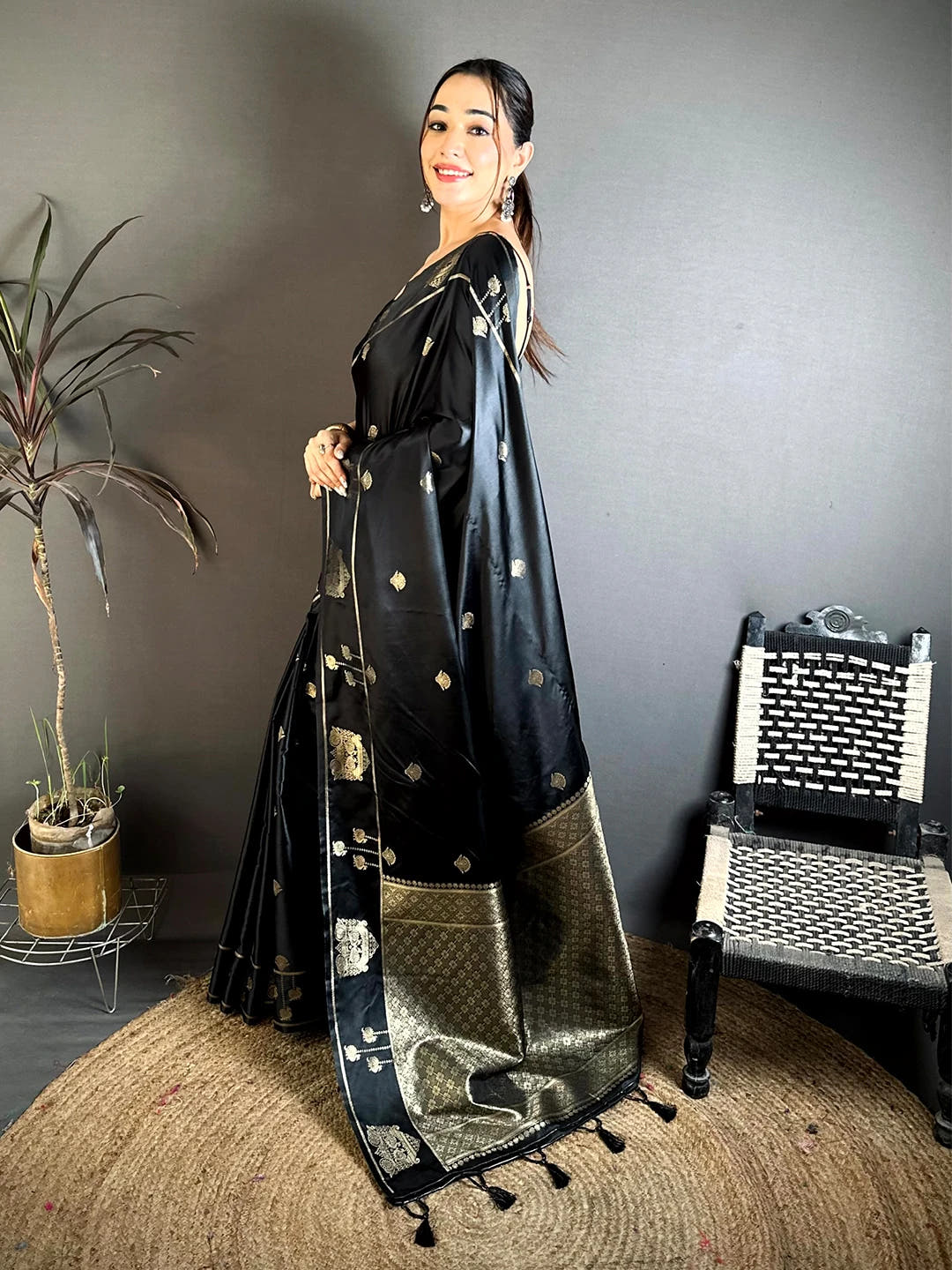 Black Mashru Satin Silk zari peacock butta saree, side view on model showing the graceful drape of the pallu from the shoulde