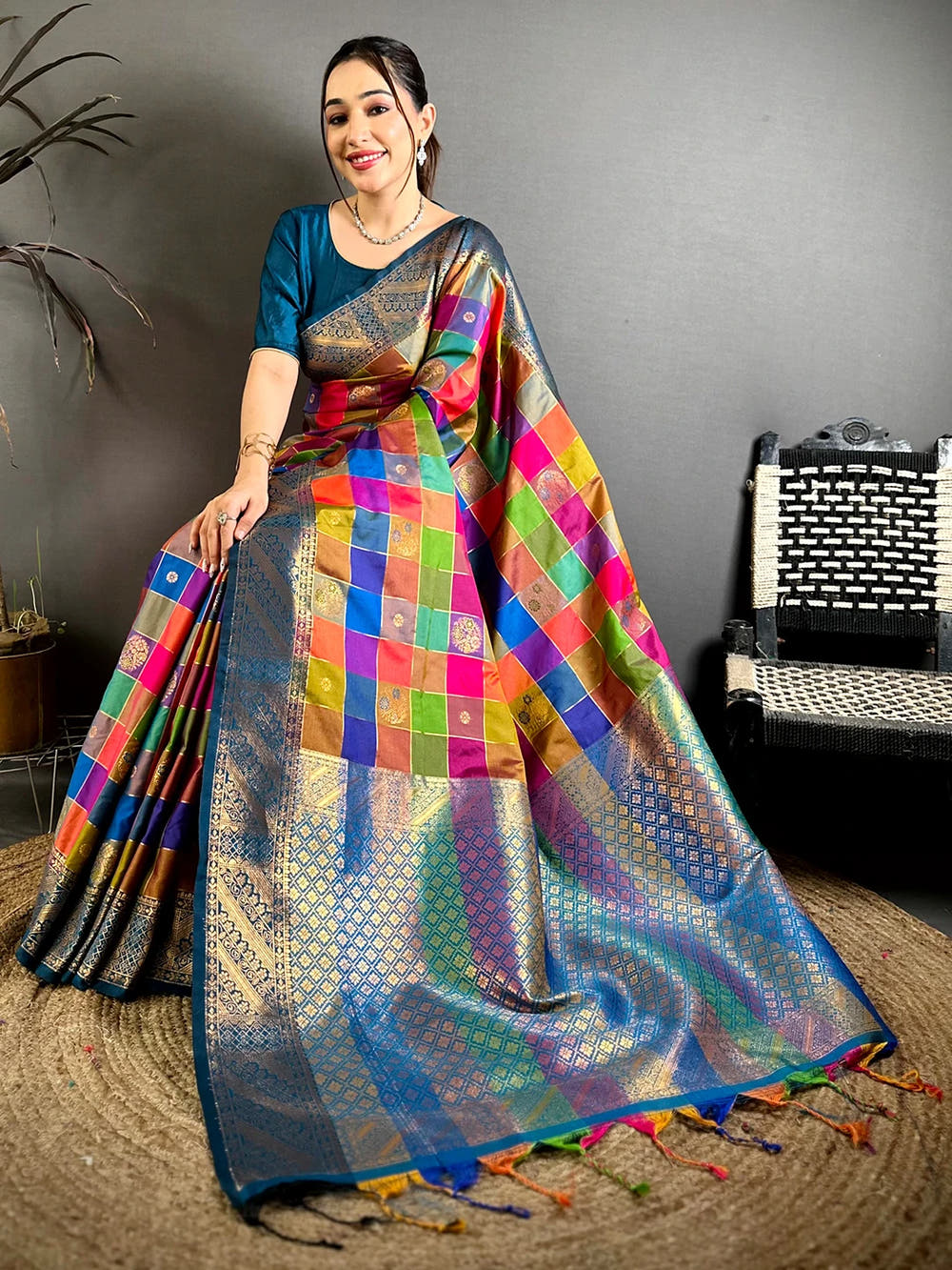 Multicolour silk minakari-style zari butti saree, pallu spread across the floor with teal border and woven zari patterns