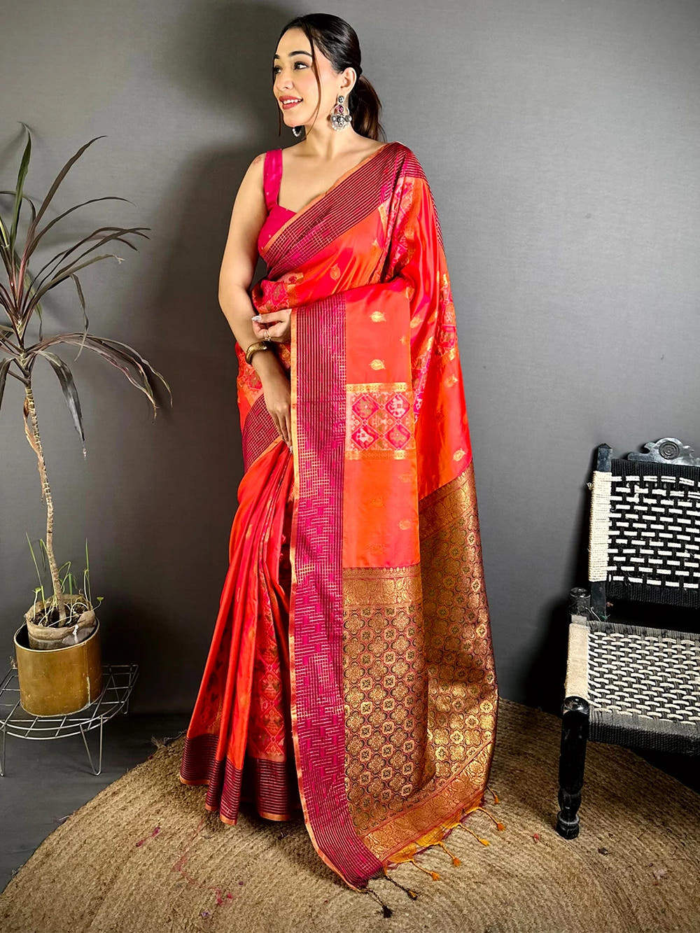 Red-orange Soft Silk Ikkat Pochampally saree, full front view on model with pink sleeveless blouse and zari-style pallu