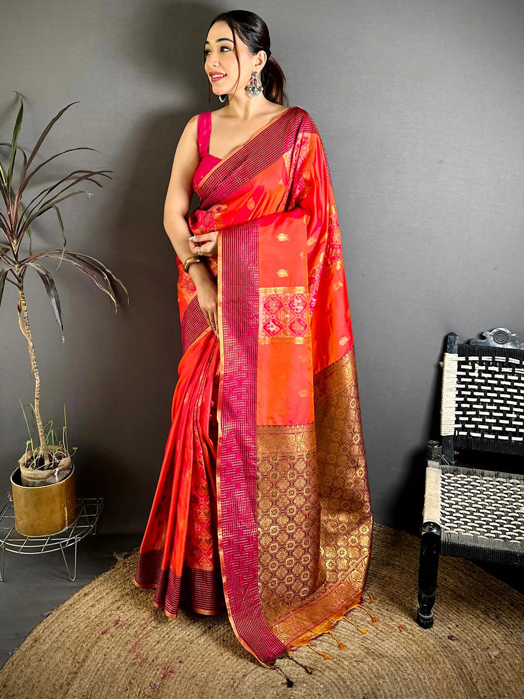 Red-orange Soft Silk Ikkat Pochampally saree, full front view on model with pink sleeveless blouse and zari-style pallu